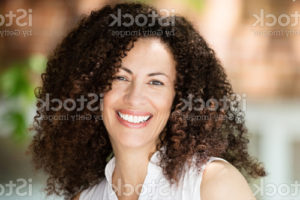 mature-ethnic-woman-smiling-at-the-camera-she-is-outside-in-front-of ...